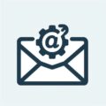Icon of an envelope with a gear and an at symbol on top, representing email settings or configuration, ideal for showcasing Business IT Perth solutions.